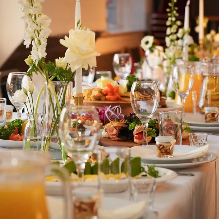 A table laid with flowers and cold starters for a celebration